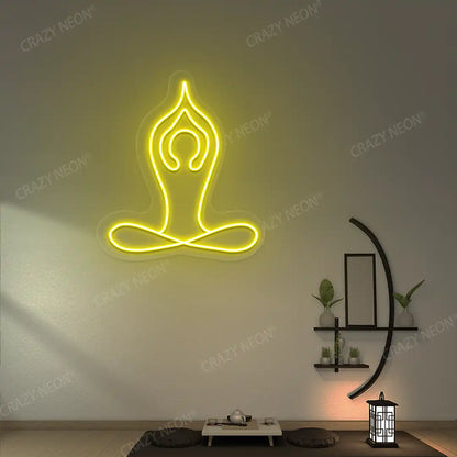 Padmasana With Raised Arms Yoga Neon Sign lighting up in yellow color in a yoga room