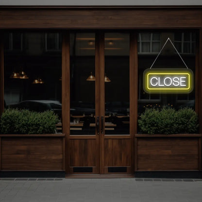 horizontal close neon sign glowing in yellow color on a window