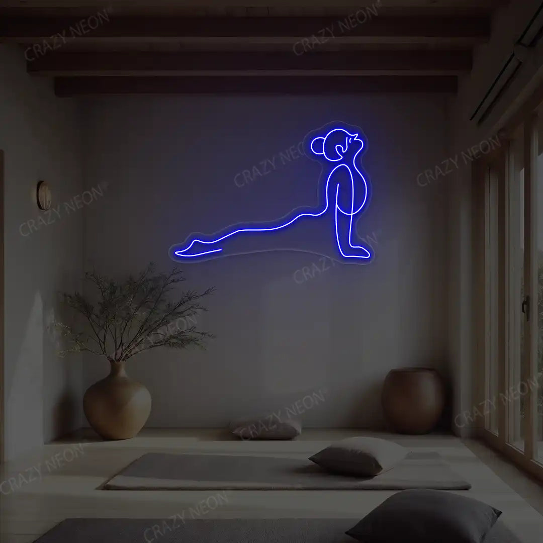 Urdhva Mukha Svanasana Yoga Neon Sign lighting up in blue color in a yoga room