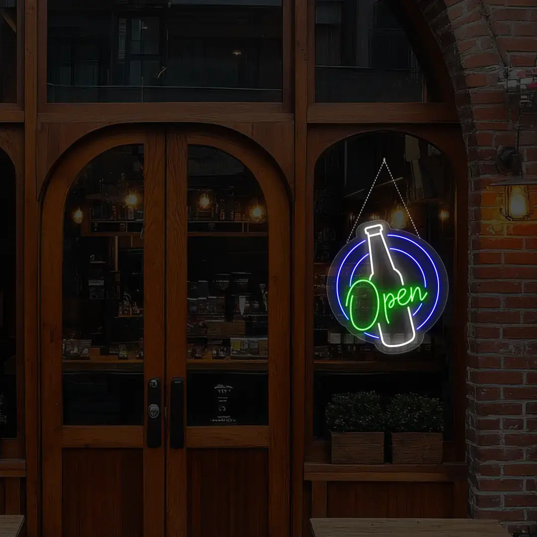 green beer open neon sign hanging on a window