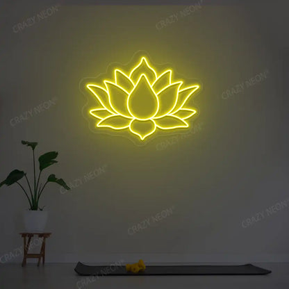 Lotus Flower Neon Sign lighting up in yellow color in a yoga room