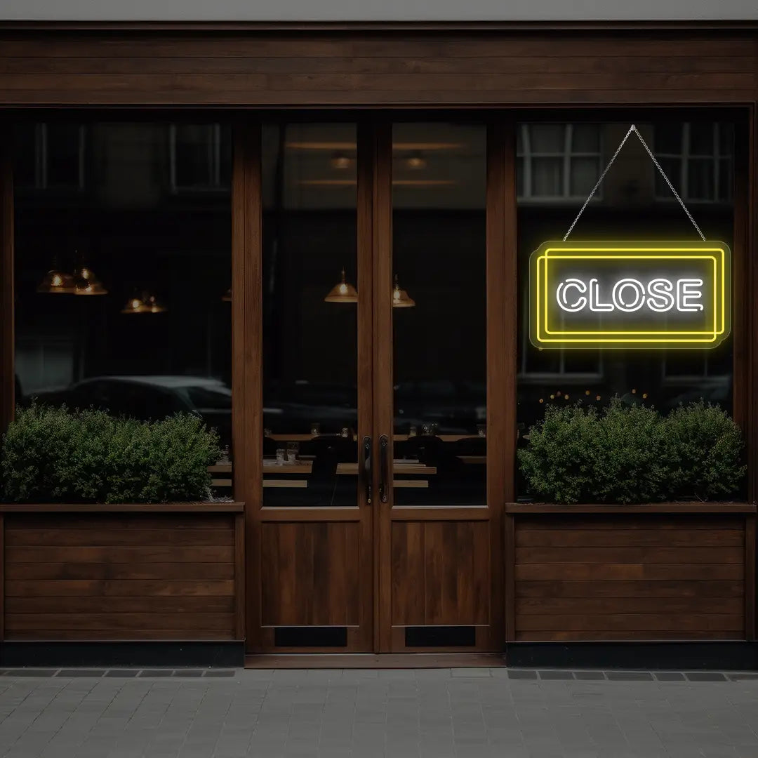 yellow close neon sign hanging on a  window