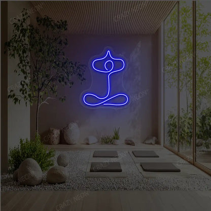 Sukhasana With Arms Raised Contour Yoga Neon Sign glowing in blue color in a yoga room