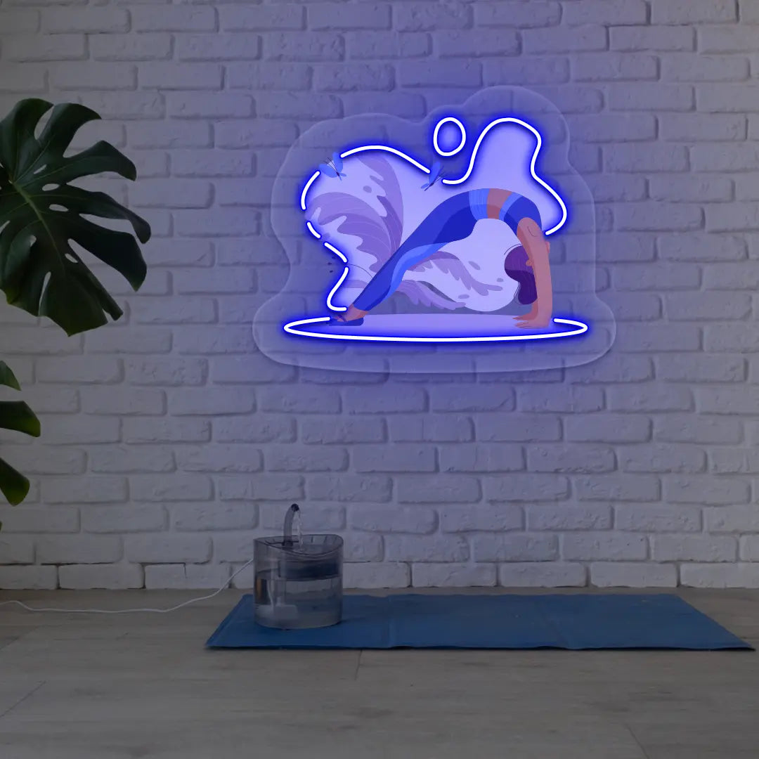Urdhva Dhanurasana Yoga Neon Artwork lighting up in blue color in a yoga room