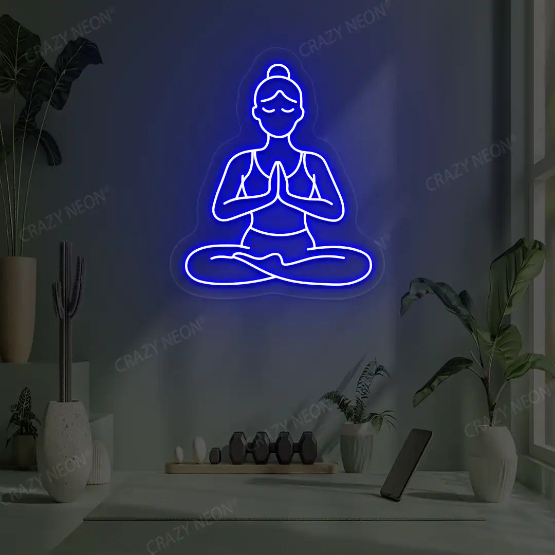 Padmasana Anjali Mudra Yoga Neon Sign lighting up in blue color in a yoga room