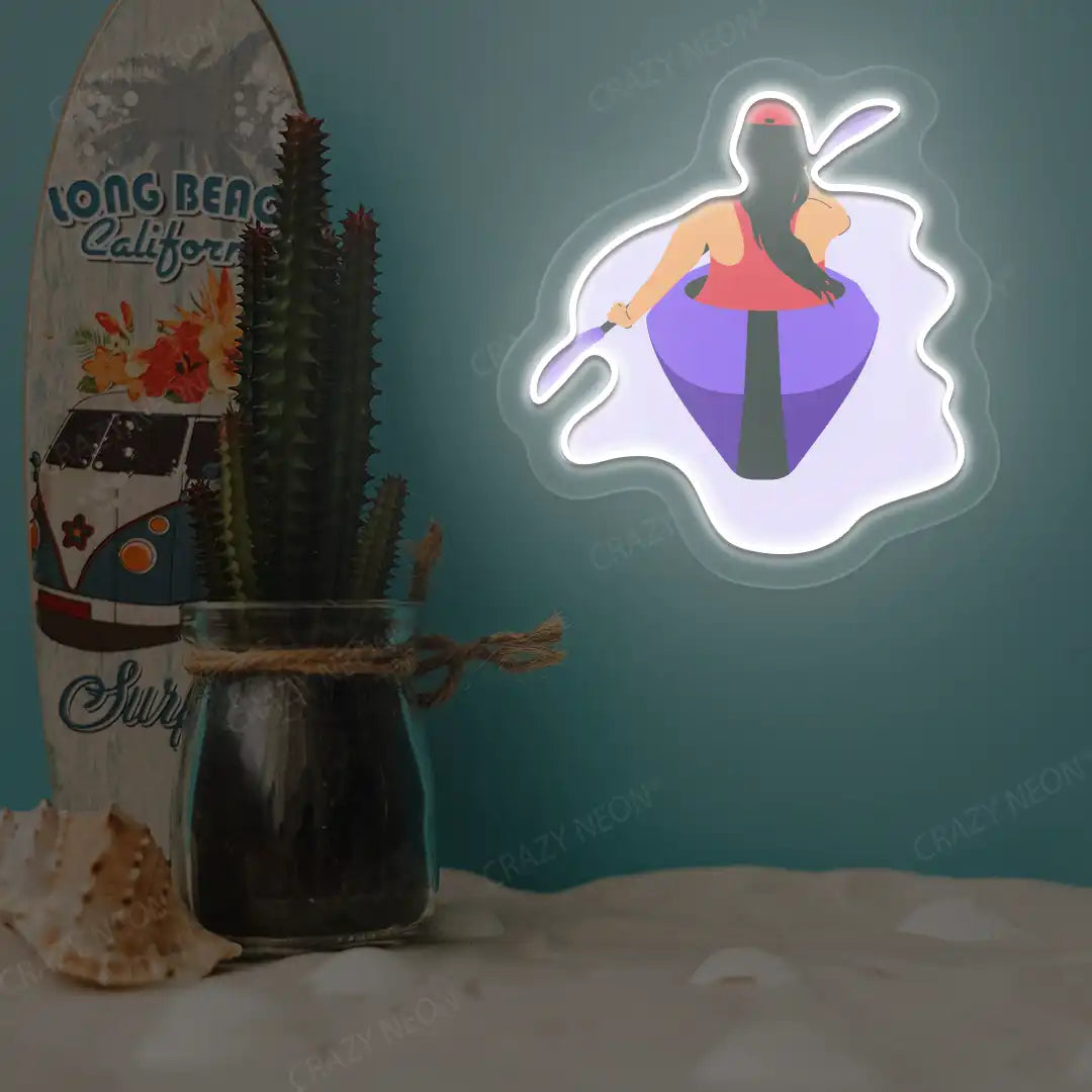 warm white woman kayaking neon artwork mounted on a wall