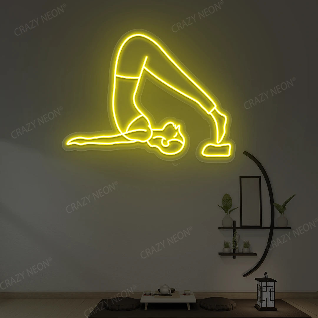 Halasana Yoga Neon Sign glowing in yellow color in a yoga room