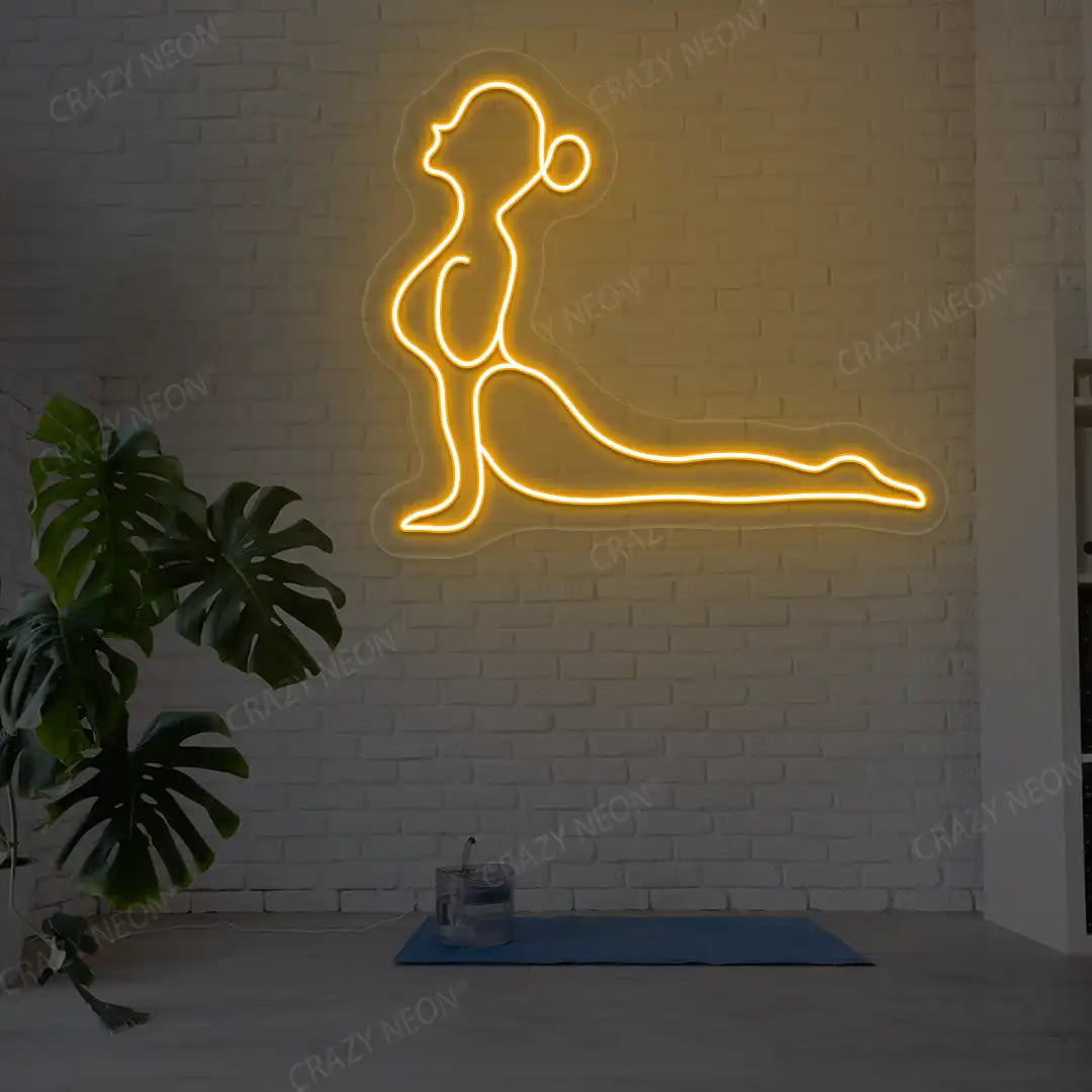 Bhujangasana Yoga Neon Sign glowing in orange color in a yoga room