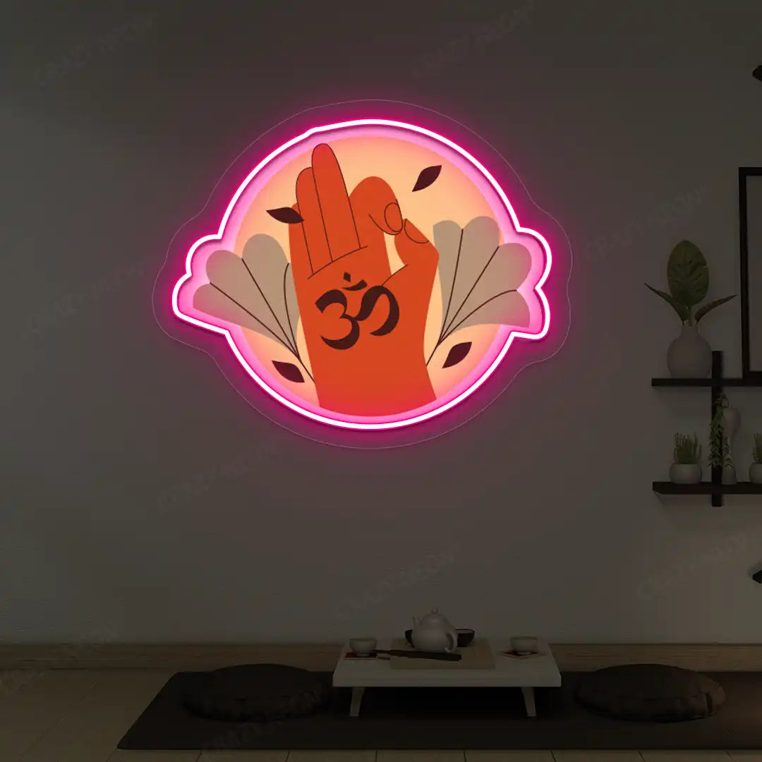 Om Gyan Mudra Neon Artwork lighting up in pink color in a yoga room