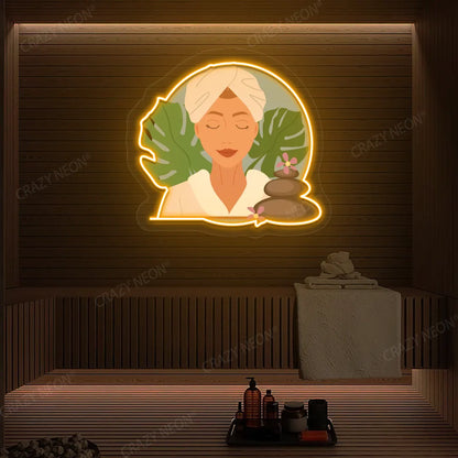 Zen Facial Spa Neon Artwork lighting up in orange color on a wooden spa wall