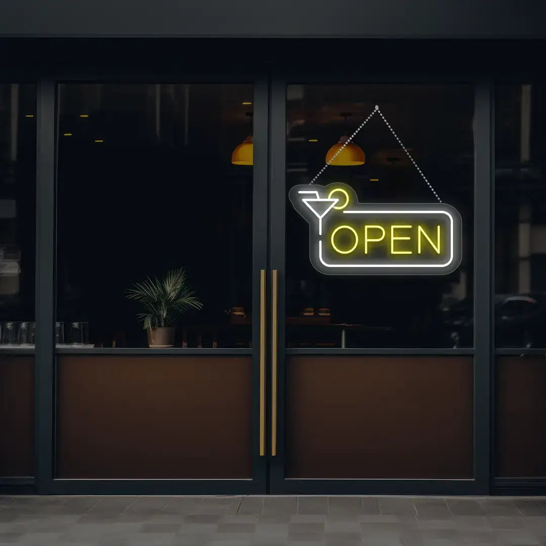 yellow martini open neon sign hanging on a window