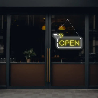 yellow martini open neon sign hanging on a window