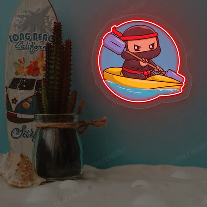 red ninja kayaking neon artwork mounted on a wall