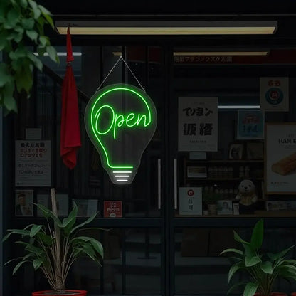 green bulb open neon sign hanging on a window