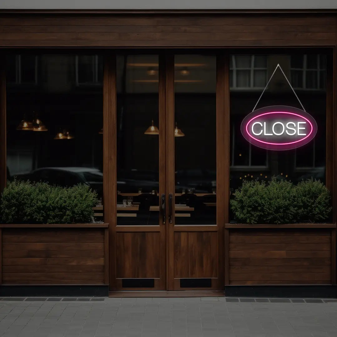 pink oval close neon sign hanging on a window