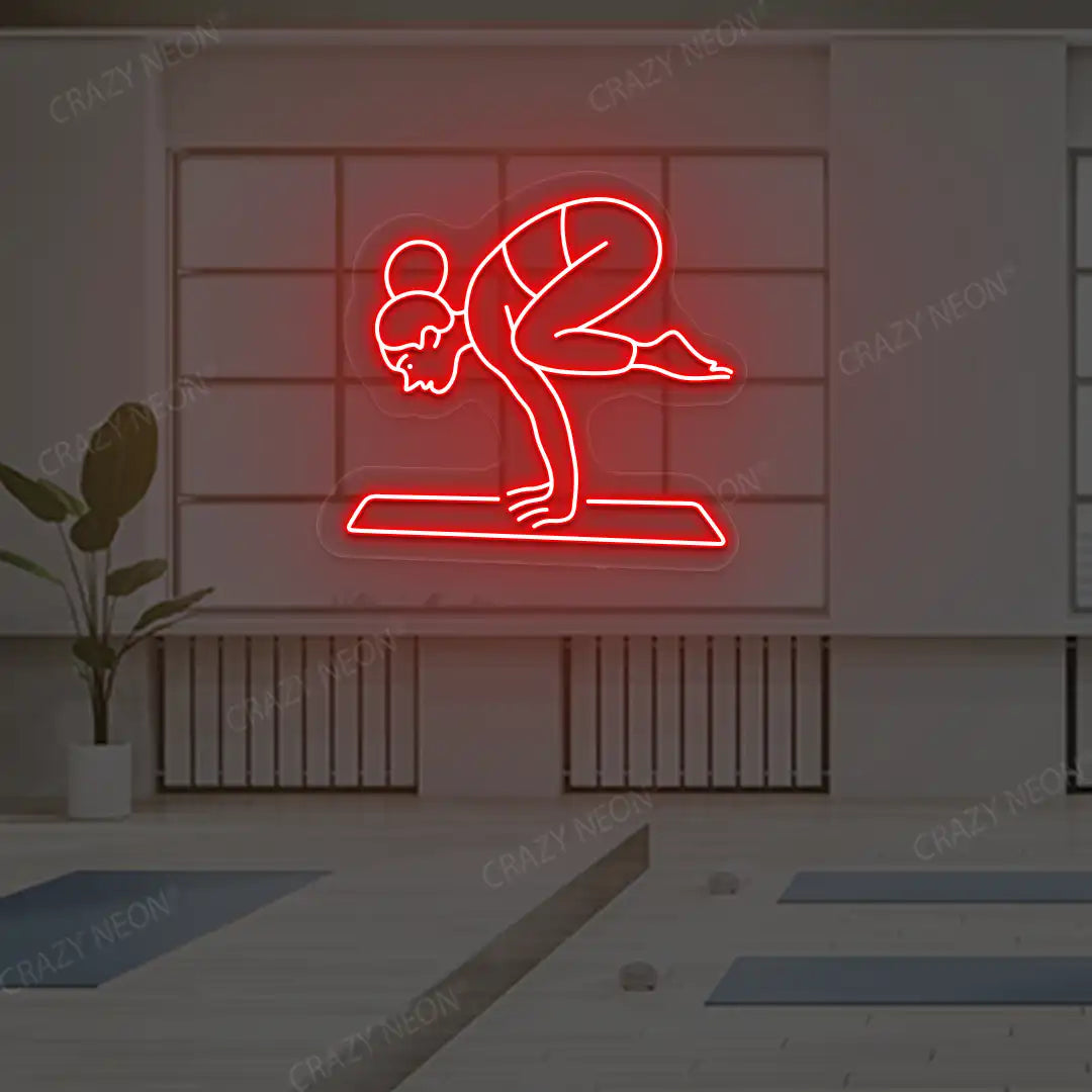 Bakasana Yoga Neon Sign lighting up in red color in a yoga room