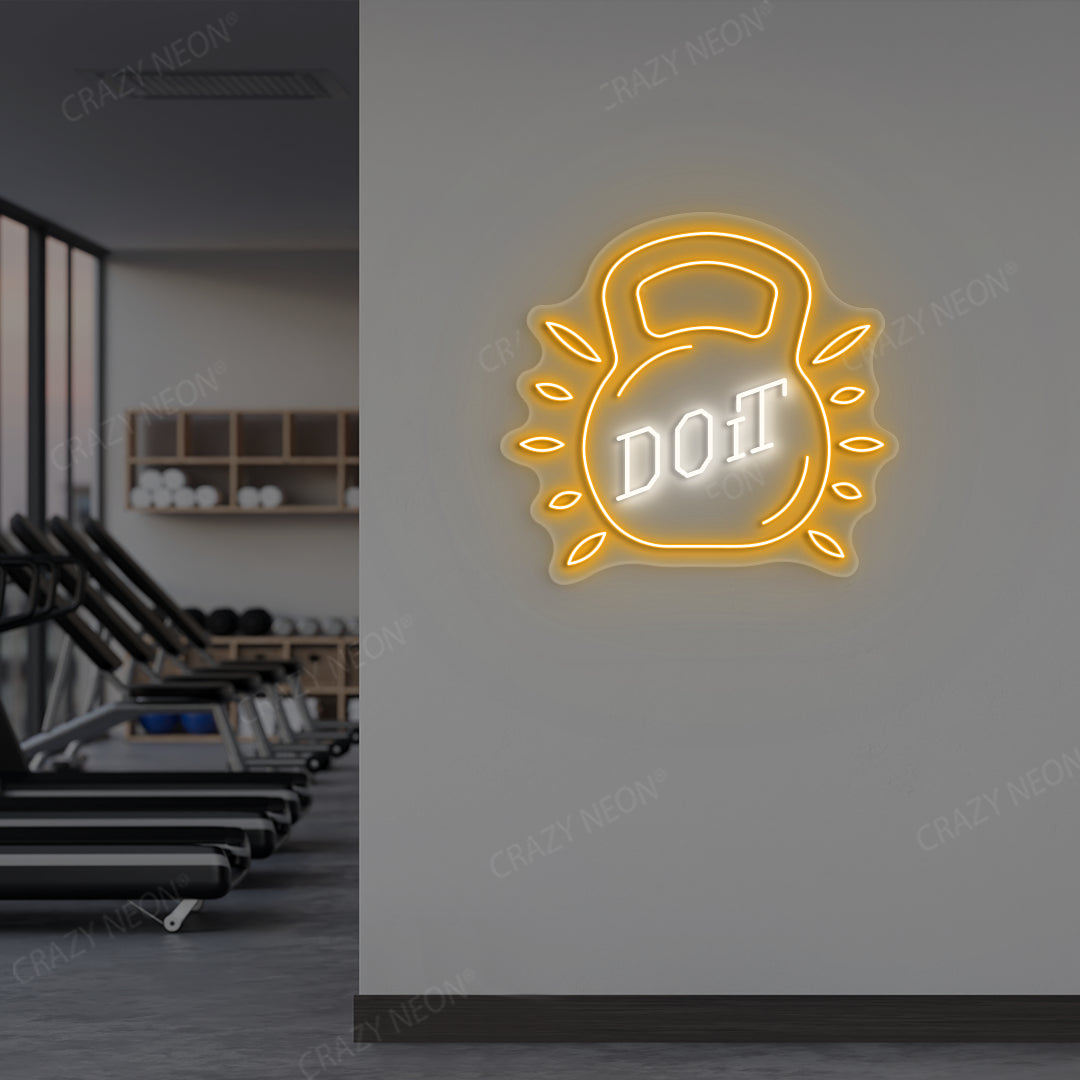 orange and white do it kettlebell gym neon sign mounted on a wall