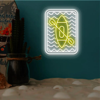 yellow and white kayak ocean waves neon sign mounted on a wall