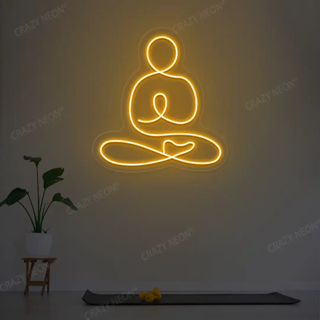 Swastikasana Yoga Neon Sign lighting up in orange color in a yoga room
