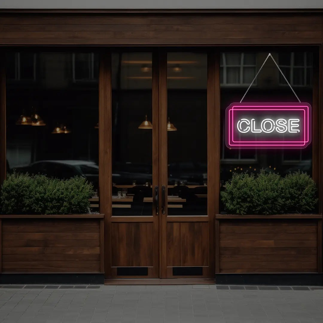 pink close neon sign hanging on a  window