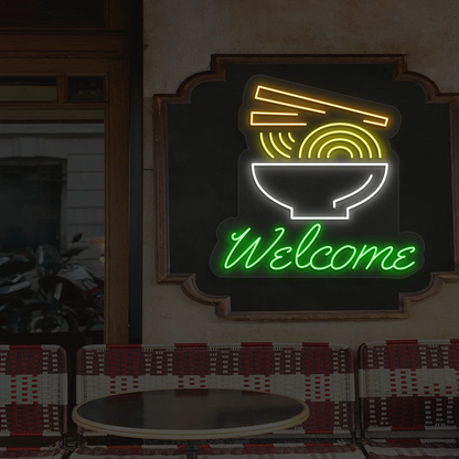 green white yellow and orange welcome noodle bowl neon sign mounted on a wall