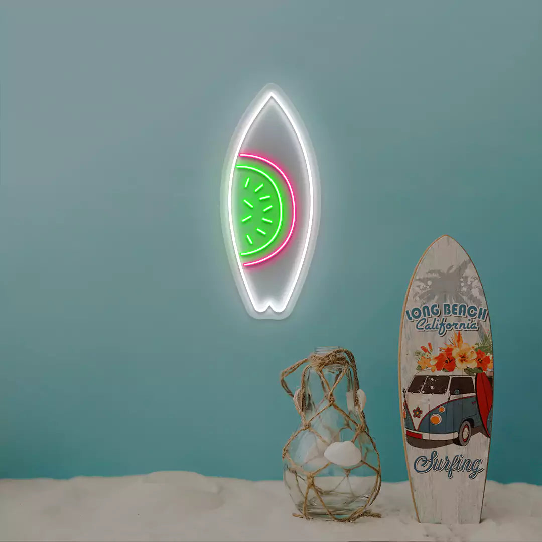 green pink and white watermelon surfboard neon sign mounted on a wall