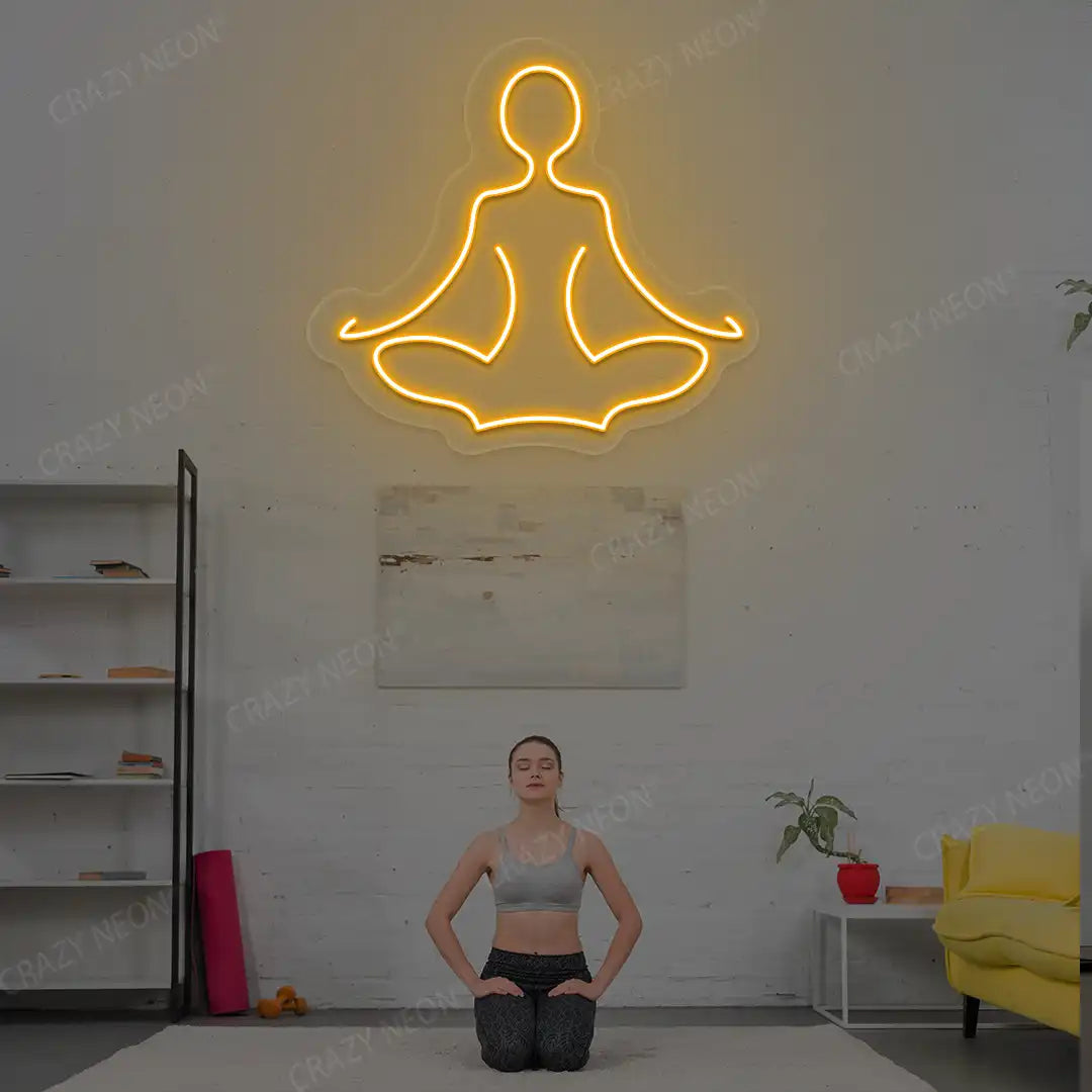 Sukhasana Yoga Neon Sign lighting up in orange color in a yoga room
