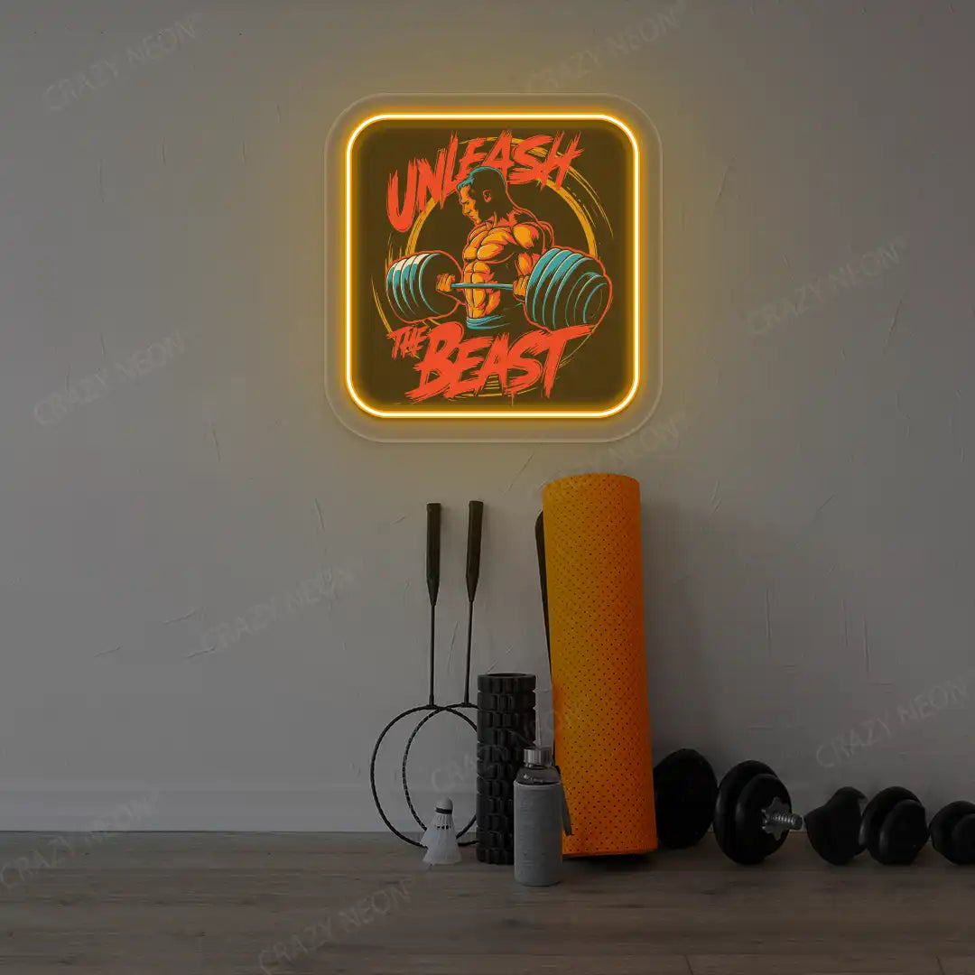 orange unleash the beast gym neon artwork mounted on a wall