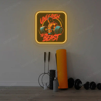 orange unleash the beast gym neon artwork mounted on a wall