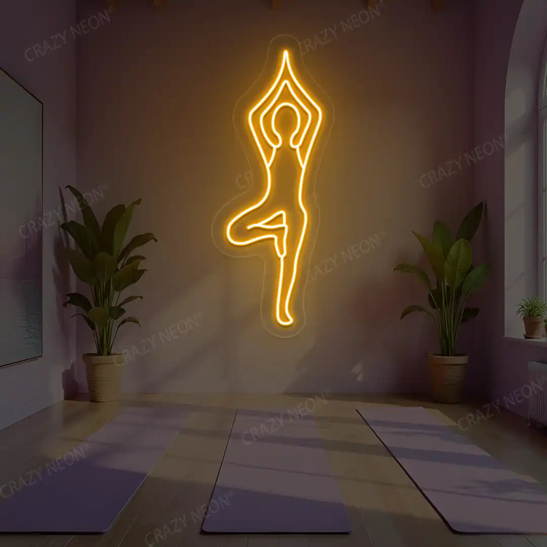 Vrikshasana Yoga Neon Sign lighting up in orange color in a yoga room