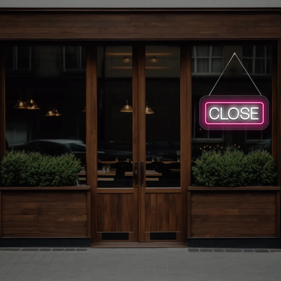 horizontal close neon sign glowing in pink color on a window