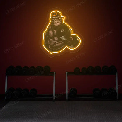 orange gorilla dumbbell lifting gym neon artwork mounted on a wall