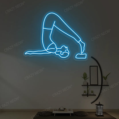 Halasana Yoga Neon Sign glowing in ice blue color in a yoga room