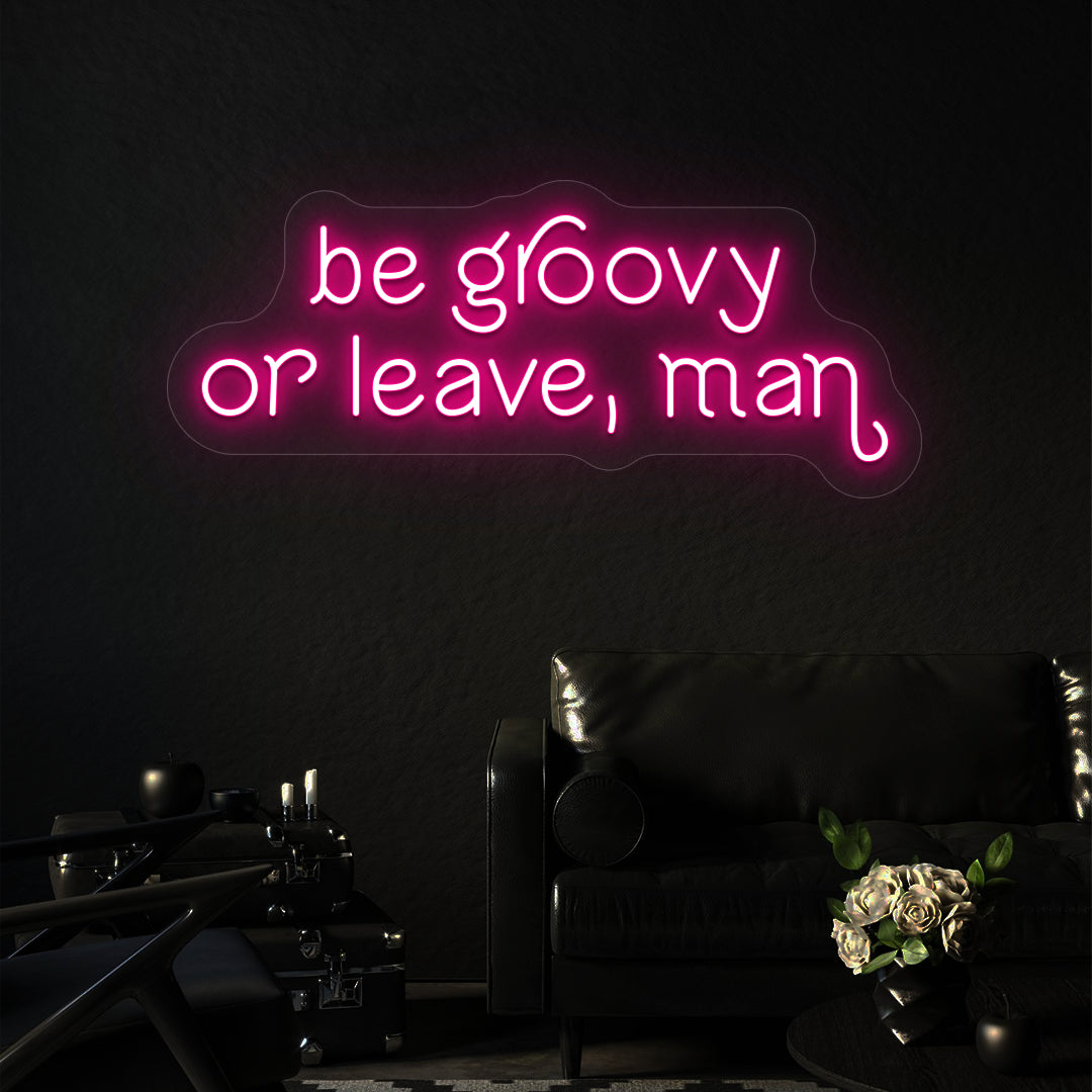 pink be groovy or leave, man vintage neon sign mounted on a wall