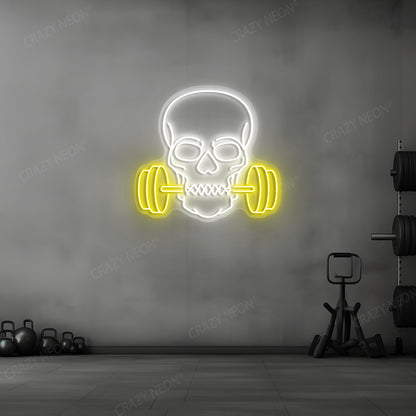 yellow and white skull barbell gym neon sign mounted on a wall