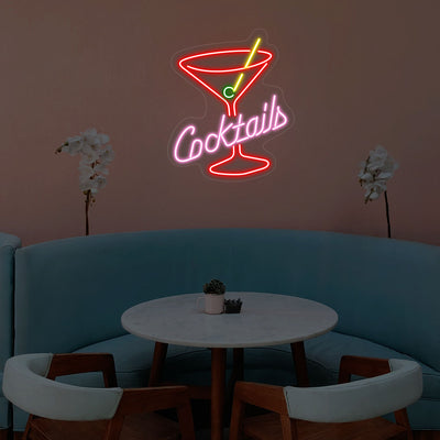 red pink and yellow cocktails glass bar neon sign mounted on a wall