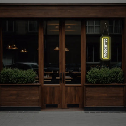yellow vertical close neon sign hanging on a window
