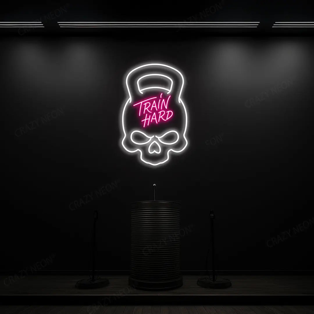 pink and white train hard kettlebell neon sign mounted on a wall