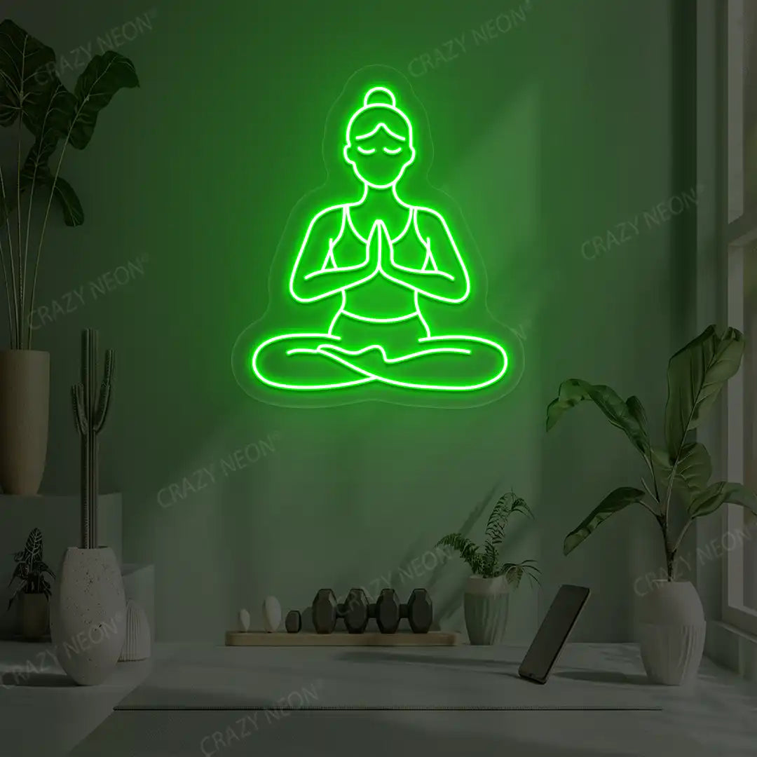 Padmasana Anjali Mudra Yoga Neon Sign lighting up in green color in a yoga room