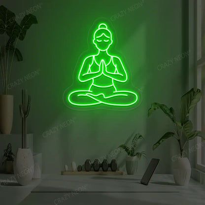 Padmasana Anjali Mudra Yoga Neon Sign lighting up in green color in a yoga room