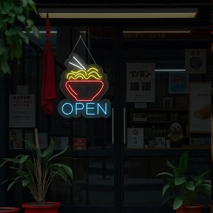 ice blue noodles open neon sign hanging on a window