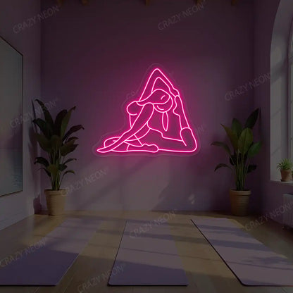 Eka Pada Rajakapotasana Yoga Neon Sign lighting up in pink color in a yoga room