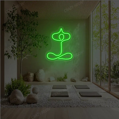 Sukhasana With Arms Raised Contour Yoga Neon Sign glowing in green color in a yoga room