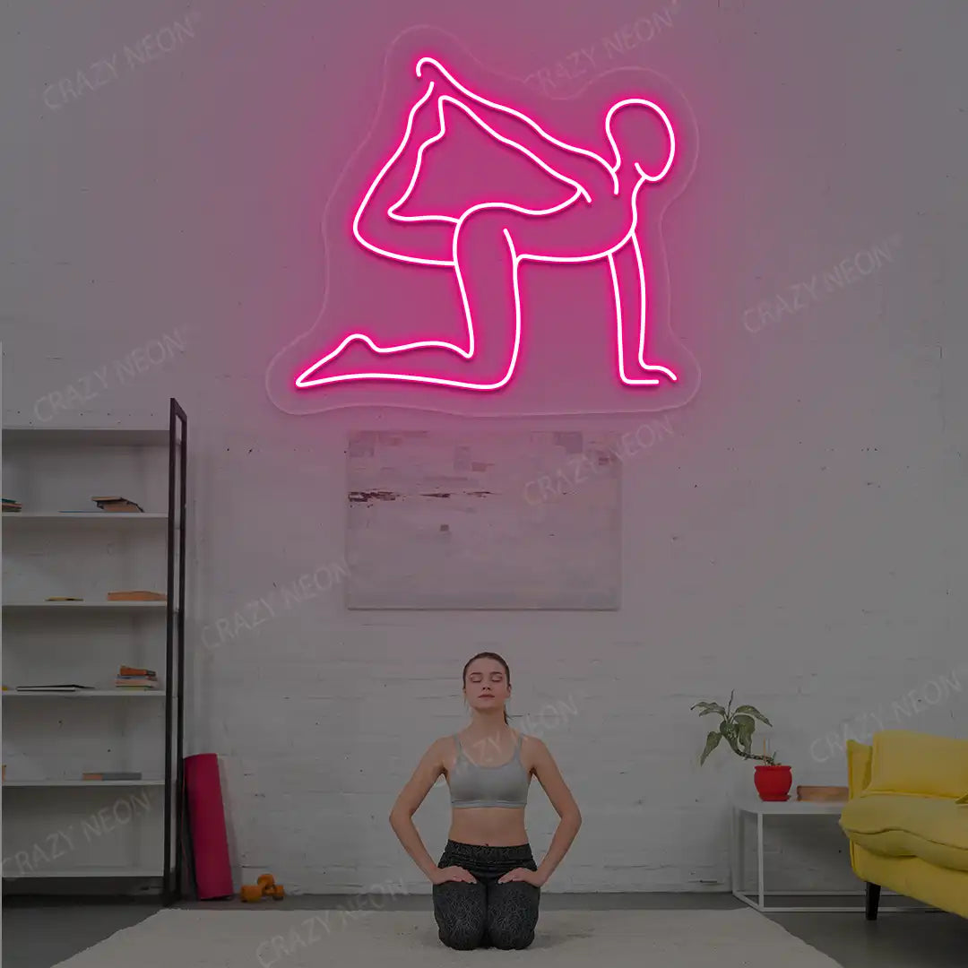 Eka Hasta Vyaghrasana Yoga Neon Sign glowing in pink color in a yoga room