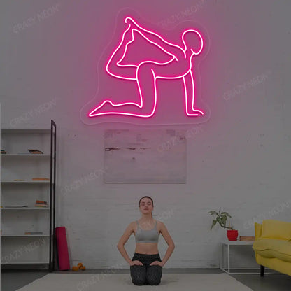 Eka Hasta Vyaghrasana Yoga Neon Sign glowing in pink color in a yoga room