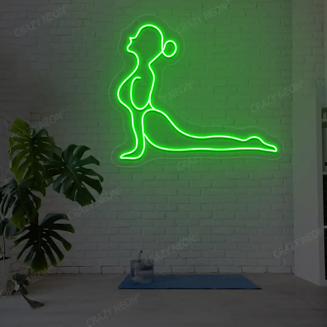 Bhujangasana Yoga Neon Sign glowing in green color in a yoga room