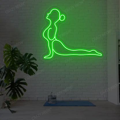 Bhujangasana Yoga Neon Sign glowing in green color in a yoga room