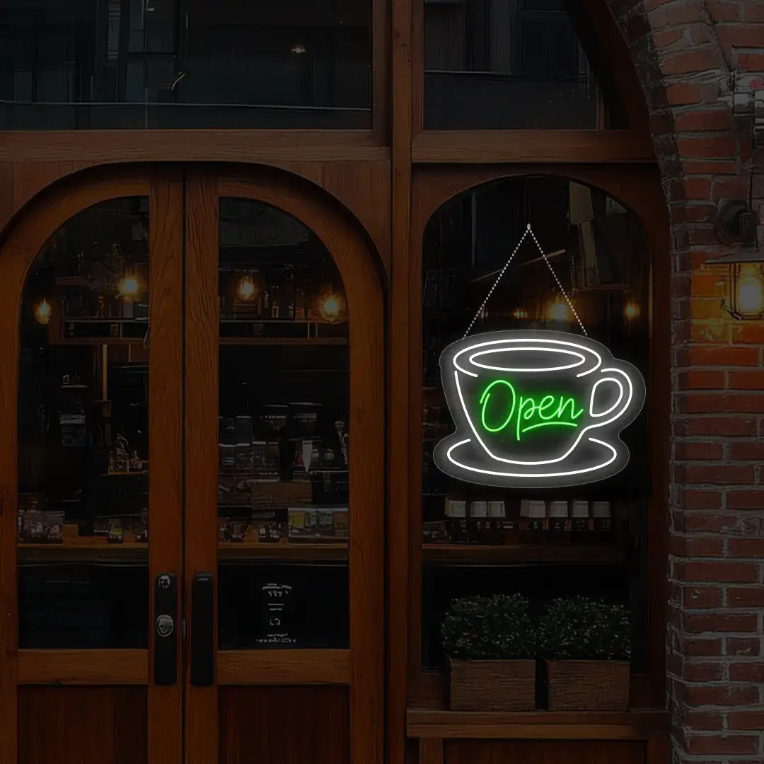 green coffee open neon sign hanging on a window