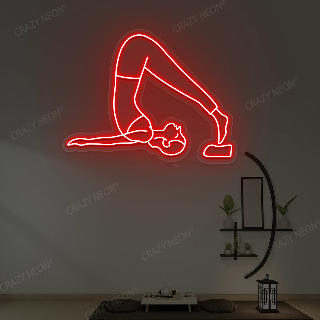 Halasana Yoga Neon Sign glowing in red color in a yoga room