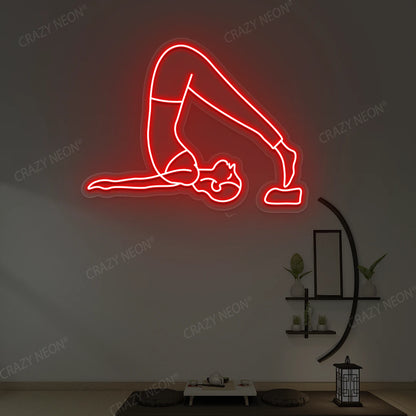 Halasana Yoga Neon Sign glowing in red color in a yoga room